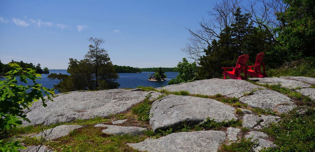 Two red chairs at a scenic point in the Ontario Frontenac Provincial Park