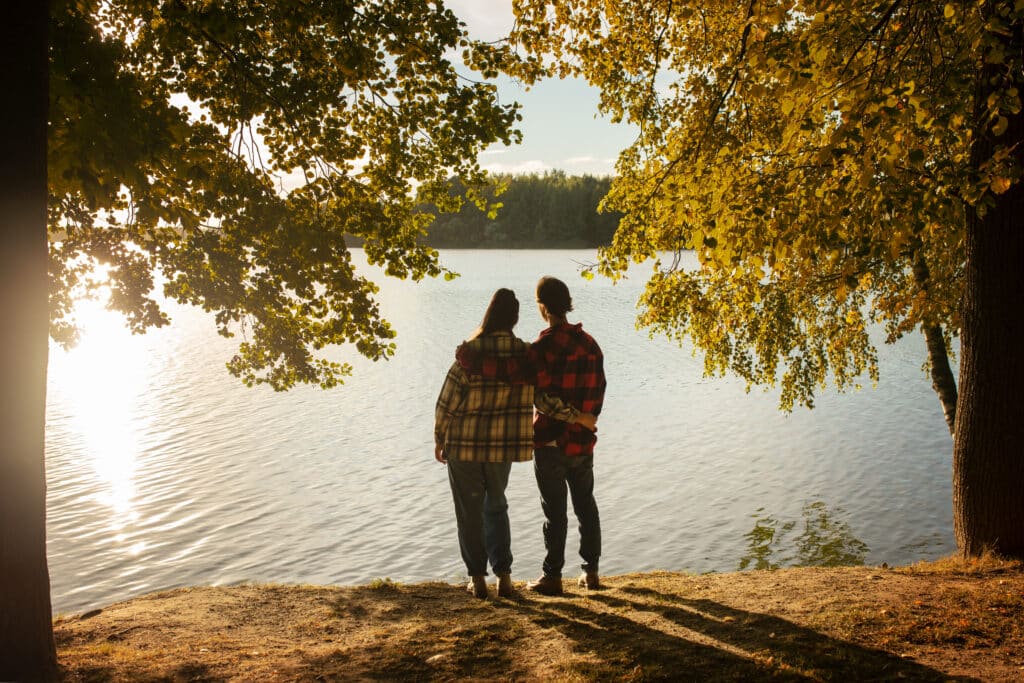 Ontario experiences for couples. Couple looking at the lake with sunset.